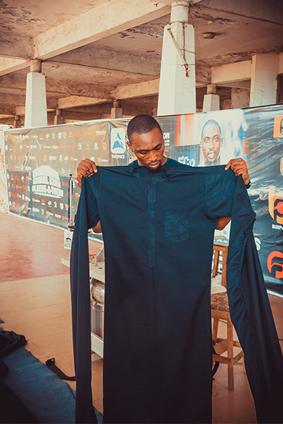 Samuel holding up the garment