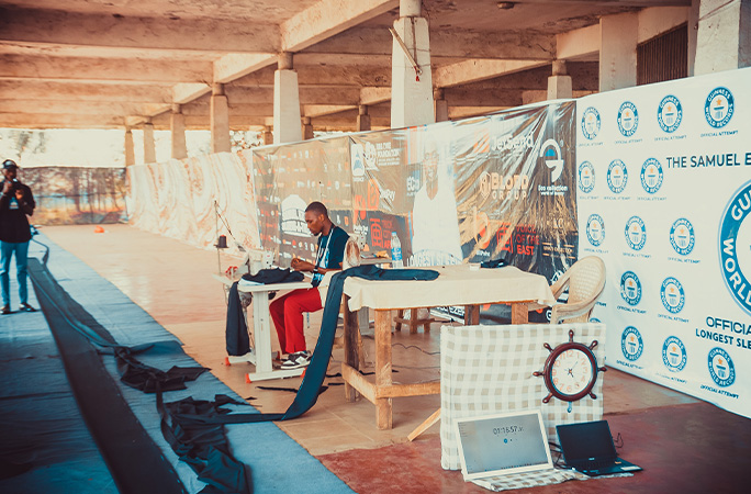 Samuel working on the garment