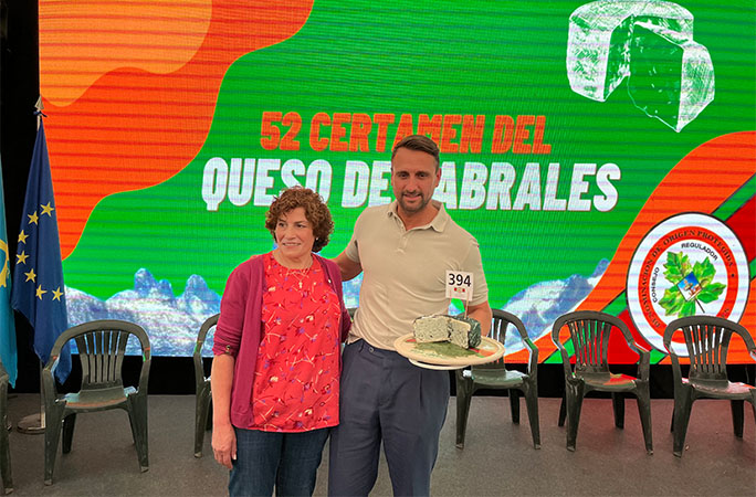 cheese held up by a man and woman
