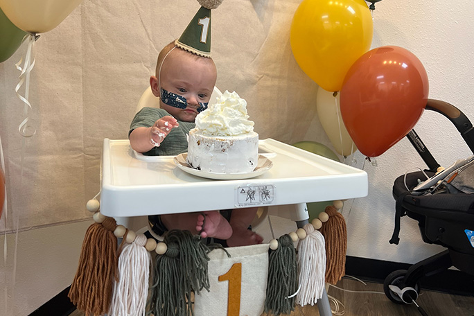 Nash Keen, most premature baby, tries some cake at his first birthday party