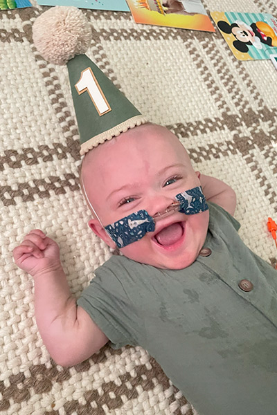 Nash Keen, most premature baby, wearing birthday hat at his first birthday