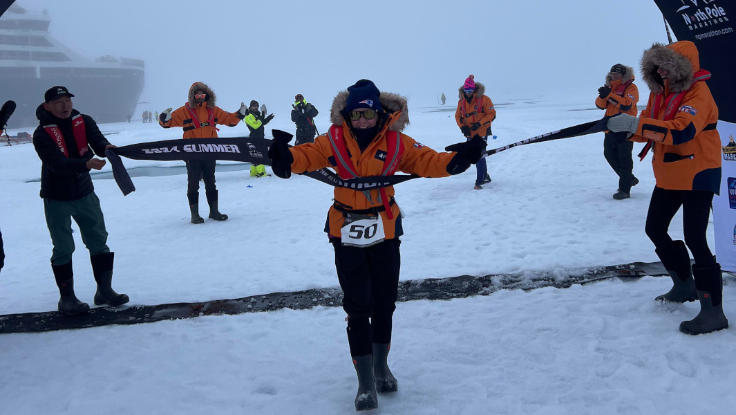Susan crossing the finish line