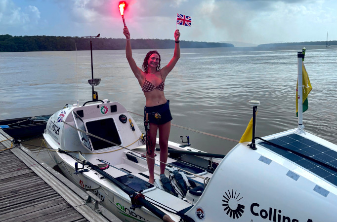 Zara holding a flare after she finished her row