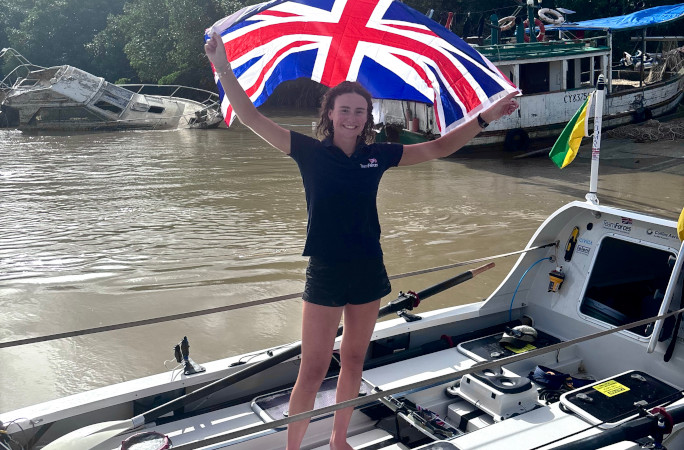 Zara holding the UK flag before her departure