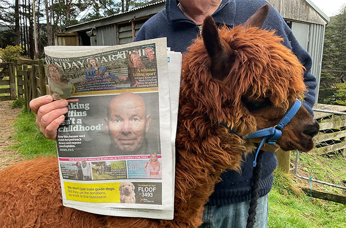Wainui with a newspaper