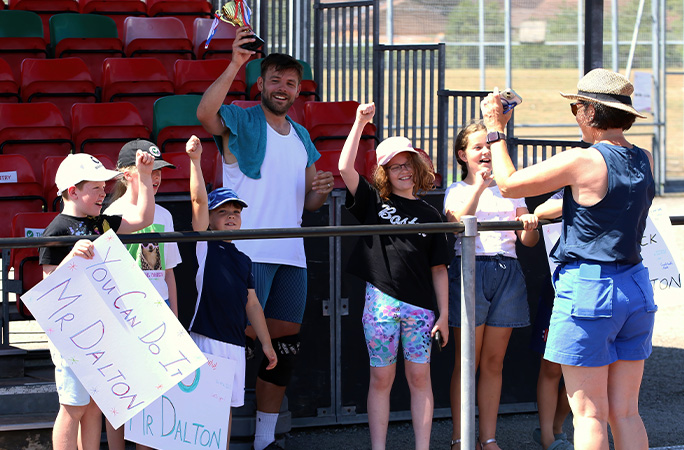 Tom with kids in the crowd