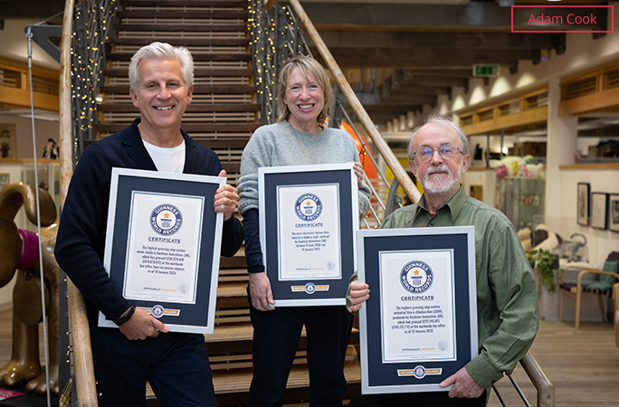 Aardman's Sean Clarke, Sarah Cox and Peter Lord stood in front of a staircase each holding a GWR certificate