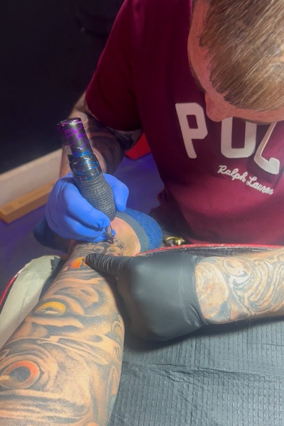 Tattooing the new little eyes on Chad's leg