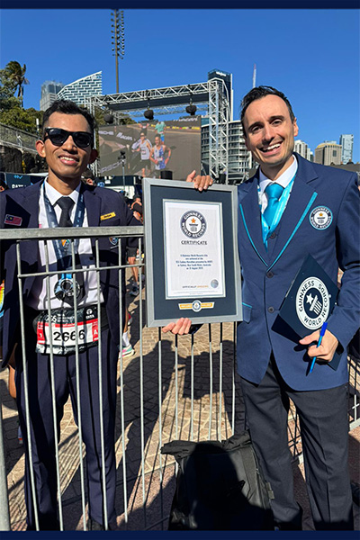 Mohd dressed in a school uniform with adjudicator