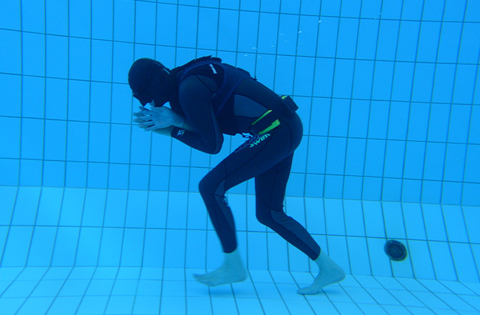 diver underwater walking to the left