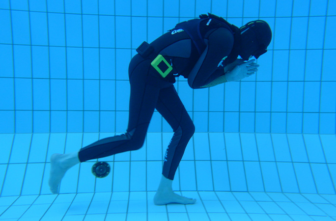 diver underwater walking to the right