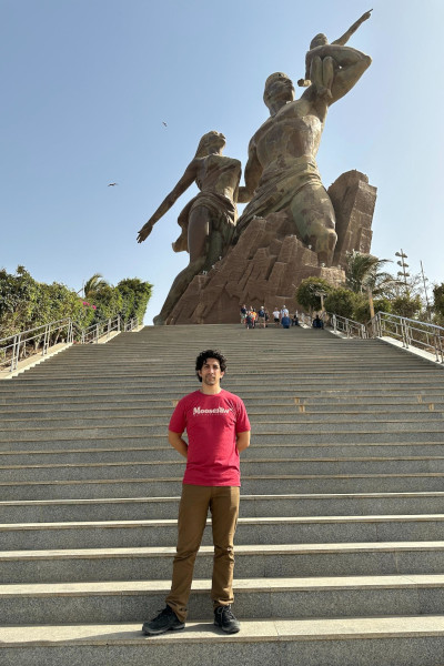 Michael in front of a statue in Senegal