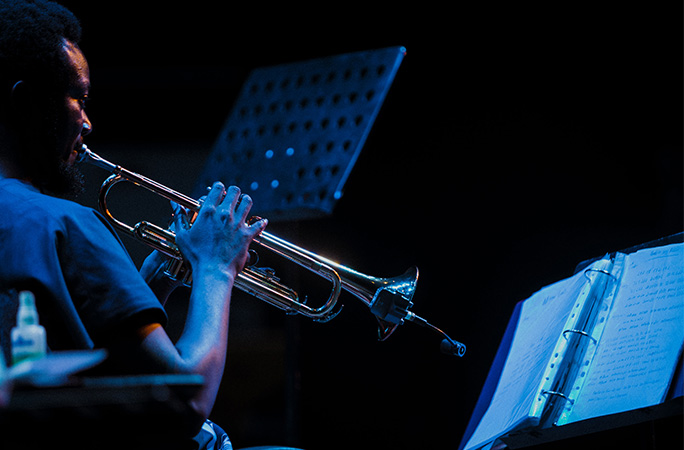 Joshua playign trumpet, seen from behind