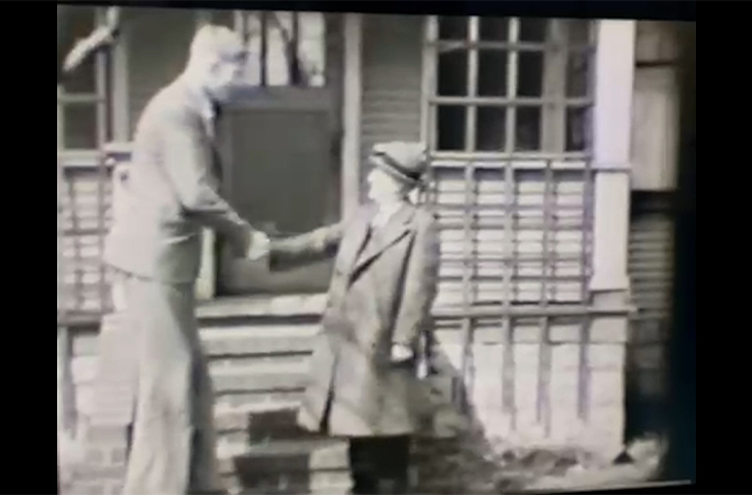 Robert shaking Maurice's hand
