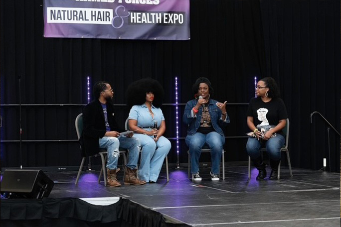 Aevin appears as a guest speaker at an armed force hair and health convention