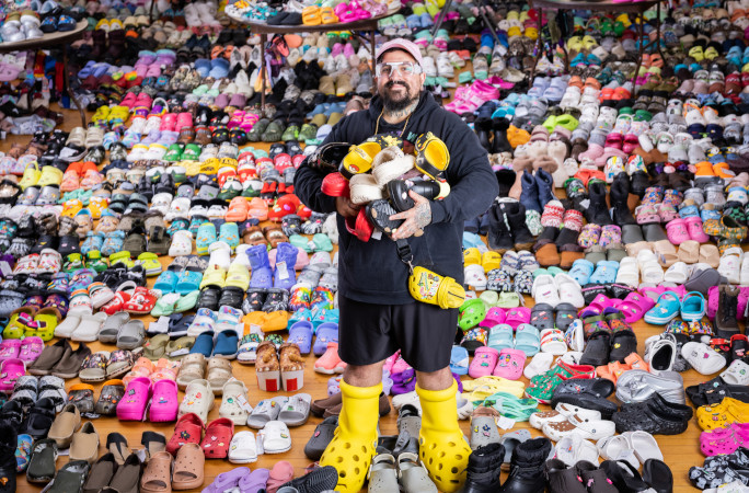 Doogie holding tons of Crocs