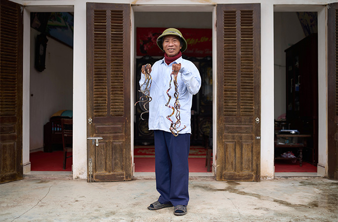 Mr Huyền outside his home