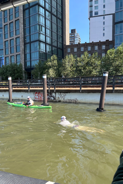 Michael swimming in front of swim related graffiti