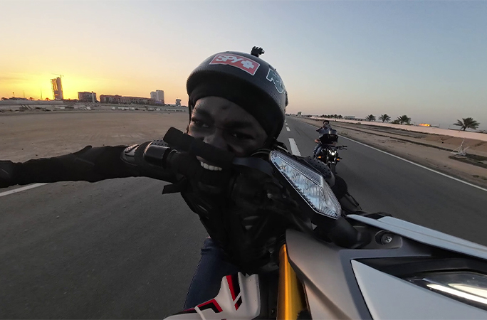 Ahmed holding the handlebar in his mouth