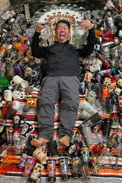 Sonny surrounded by skull drinkware