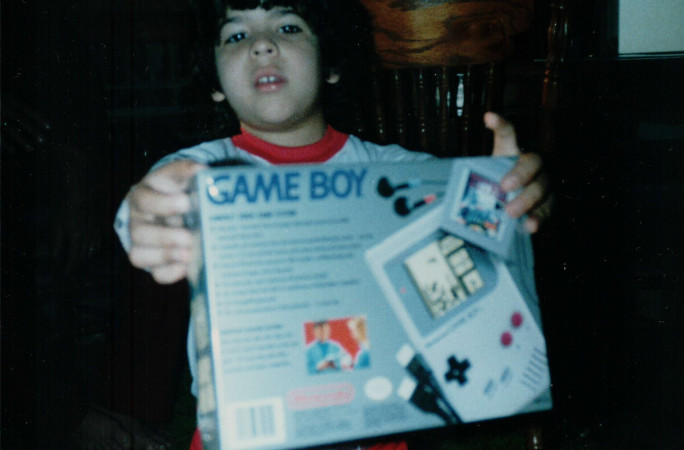 Baby Coz holding a GameBoy