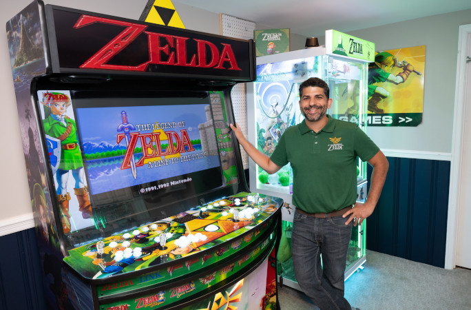 Coz posing with his arcade game