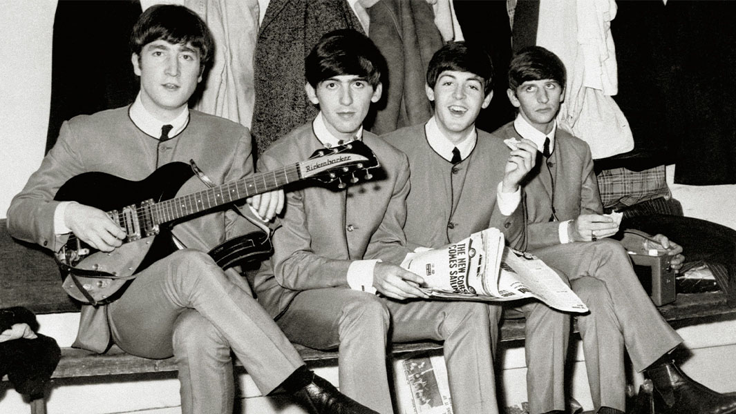 The Beatles sitting together in a line