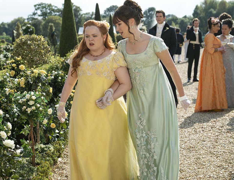 The characters of Penelope Featherington and Eloise Bridgerton wearing regency fashions