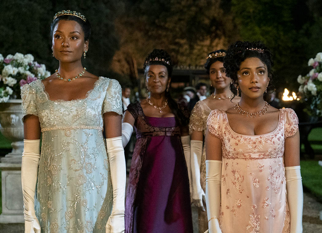 The Sharma family from Bridgerton, wearing empire-line dresses