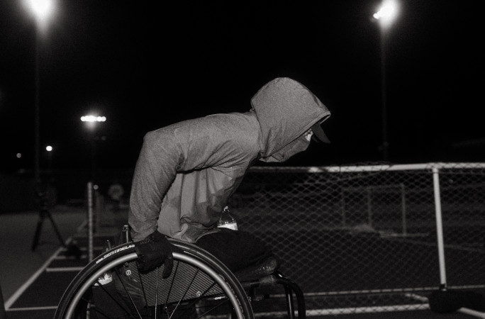 Mike pushing his wheelchair at night