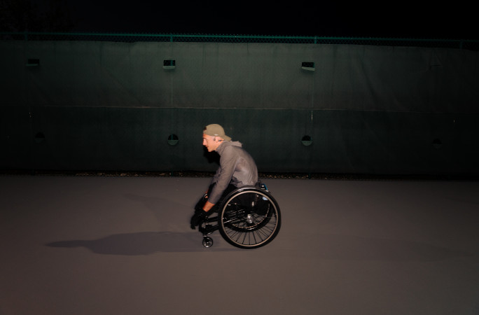 Mike pushing his wheelchair at night