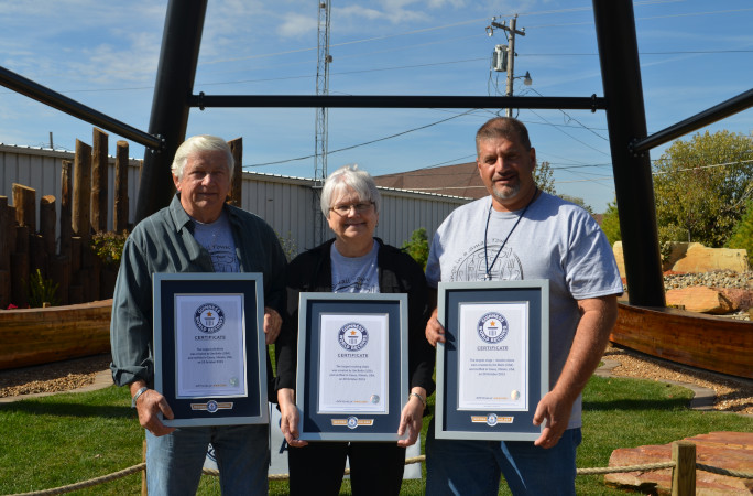 Jim holding his certificates with other community members
