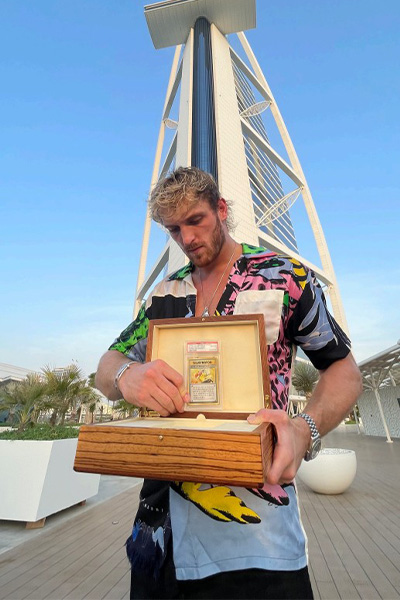 Logan holding the card in a wooden box