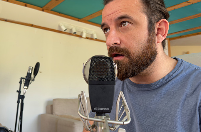 Philip singing into a microphone