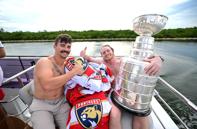 Dakota and his friend next to the Stanley Cup