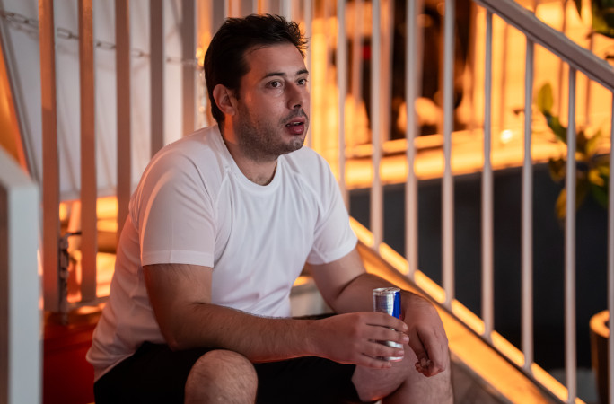 Elvis sitting outside drinking an energy drink