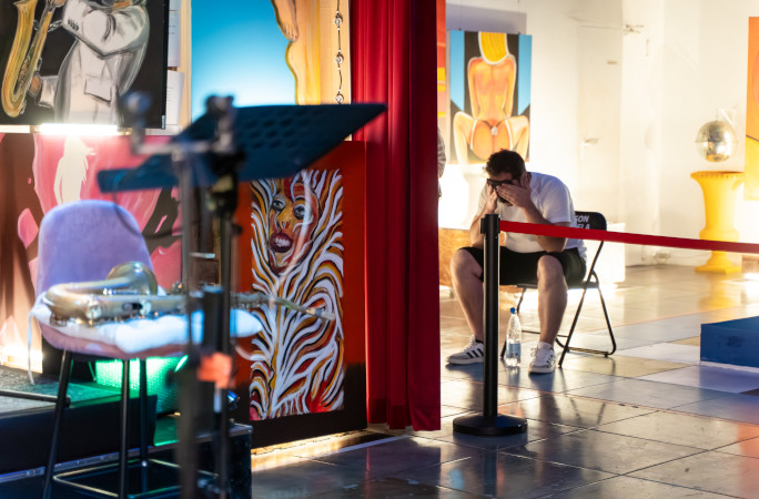 Elvis sitting with his head in his hands