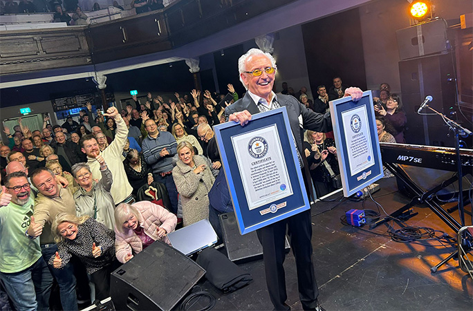 Tony on stage with his certificates