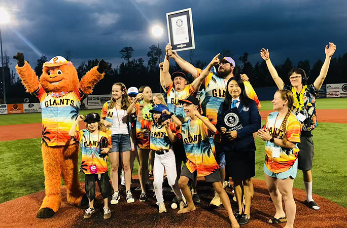 Some of the participants receiving their official certificate for the largest gathering of people weating Aloha shirts