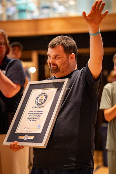 Harry waving and holding his GWR certificate