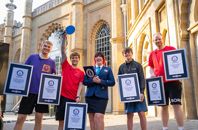 Pongfinity and Ryan holding their certificates with GWR Adjudicator Caitlin Hyem