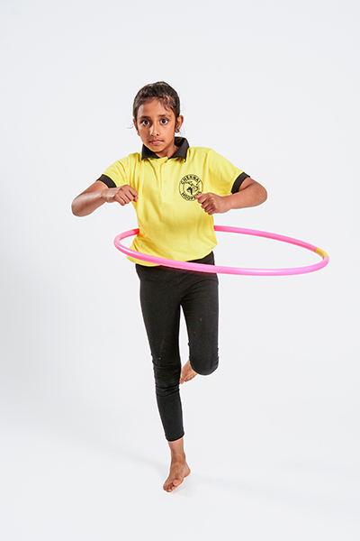 Dhanvetha hula hooping stood on one leg