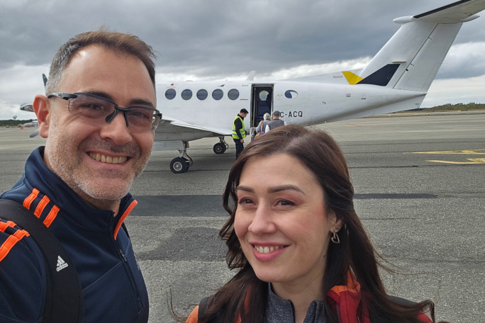 Diana and Stefan taking a selfie in front of a small plane