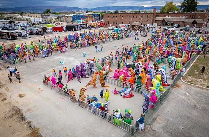 Participants in the largest gathering of people dressed as dinosaurs