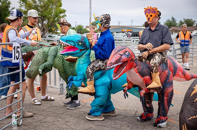 Participants in the largest gathering of people dressed as dinosaurs