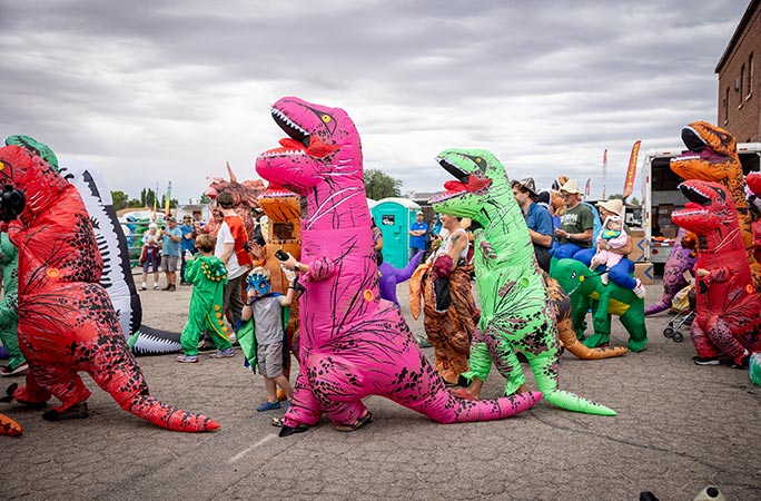 Participants in the largest gathering of people dressed as dinosaurs
