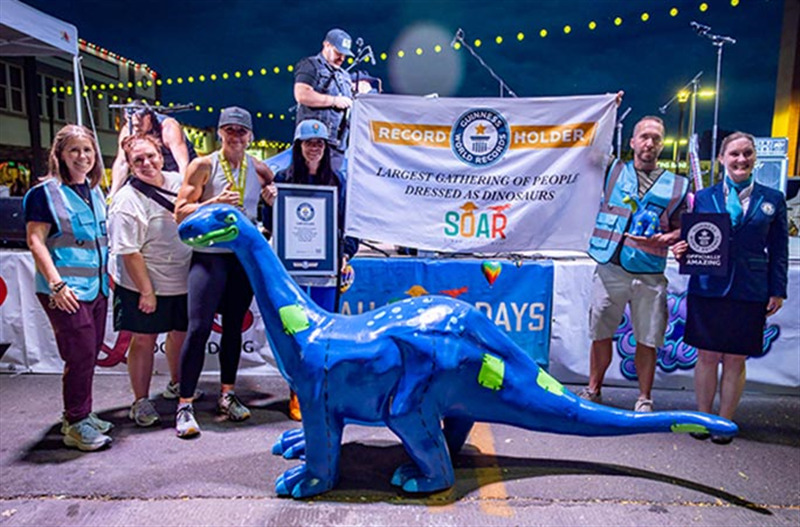 Participants in the largest gathering of people dressed as dinosaurs