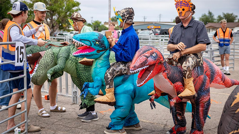 Residents of Vernal, Utah, dressed in dinosaur outfits, lining up to be counted