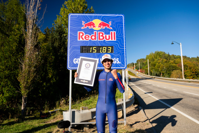 Diego holding his GWR certificate next to the Redbull sign