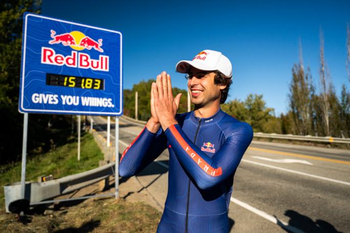 Diego doing praying hands next to the Redbull sign